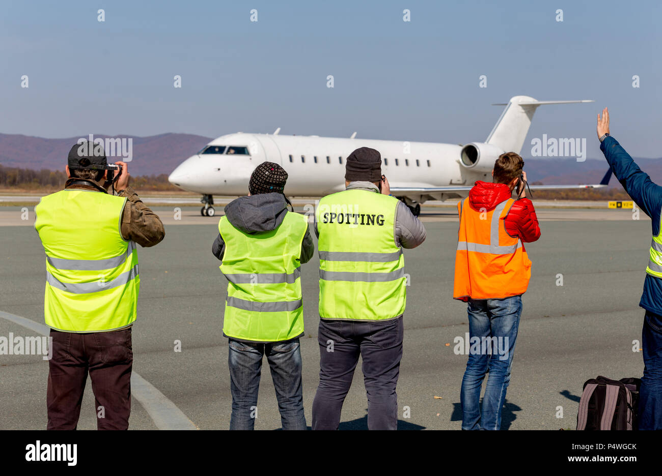 Photographers make photos of plane on runway. Plane spotting, hobby, aviation. Stock Photo