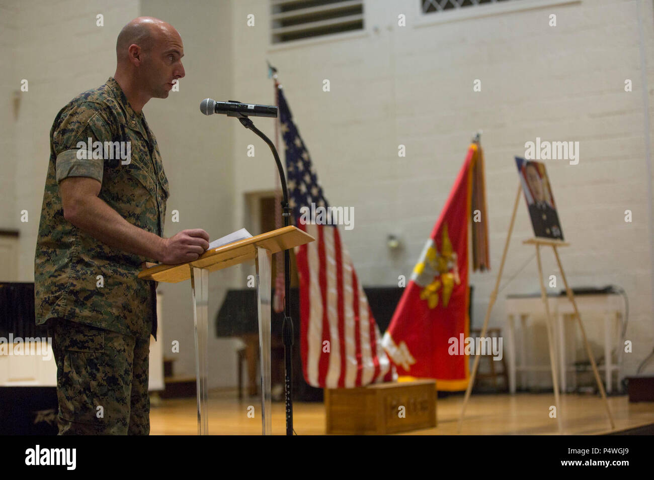 U.S. Marine Corps Chief Warrant Officer 2 John R. Handley, reads a passage during the memorial service for 1st Lt. Garrett C. Cheung on Camp Lejeune, N.C., May 9, 2017. 1st Lt. Cheung is survived by his parents, ALexander and Florence Cheung and his sister, Brigette. Stock Photo