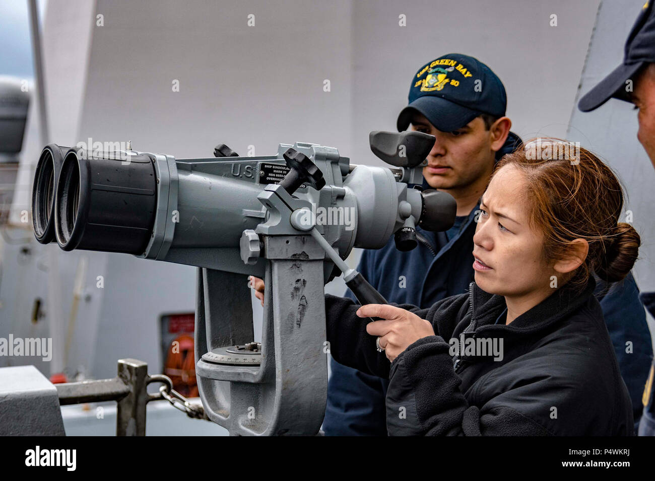SEA OF JAPAN (May 10, 2017) Senior Chief Quartermaster Donna Baraoidan, from Commander, Naval Surface Forces Type Commander Material Inspection Team, inspects binoculars aboard the amphibious transport dock USS Green Bay (LPD 20) during the ship’s Mid-Cycle Inspection (MCI). Green Bay, assigned to Commander, Amphibious Squadron 11, is conducting its MCI, which is conducted at the mid-year point prior to the Board of Inspection and Survey (INSURV) and is used to inspect and assess the material conditions of a ship. Stock Photo