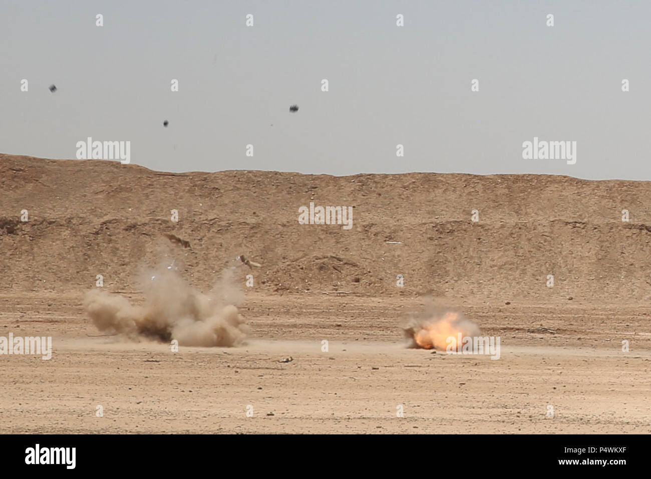 A pair of C-4 blocks explode during a demolition range at Camp Shorabak ...