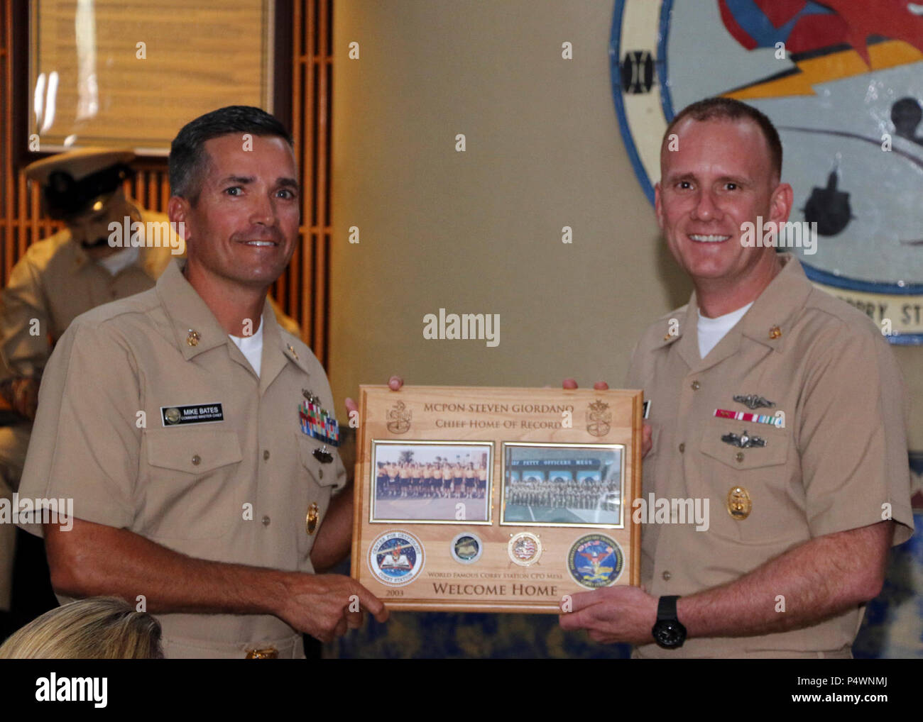 Fla. (May 9, 2017) Center for Information Warfare Training's Command Master Chief Mike Bates presents Master Chief Petty Officer of the Navy Steven Giordano with a plaque commemorating Giordano's return to Naval Air Station Pensacola Corry Station.  Giordano toured Pensacola-area commands during a two-day visit. Stock Photo