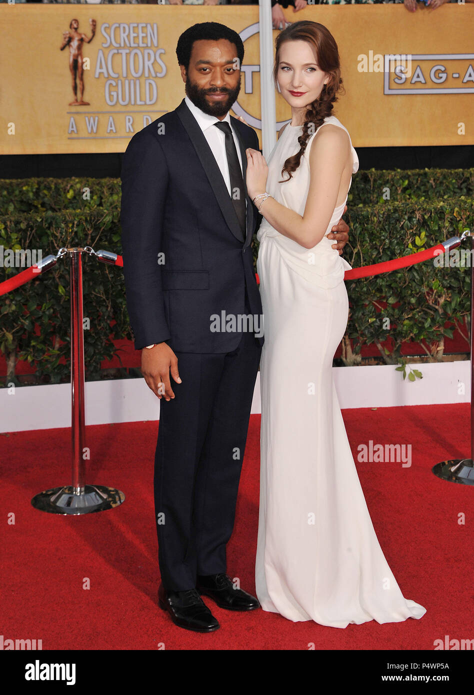 Sari Mercer, Chiwetel Ejiofor  arriving at the 20th SAG Awards 2014 at the Shrine Auditorium in Los Angeles.Sari Mercer, Chiwetel Ejiofor  ------------- Red Carpet Event, Vertical, USA, Film Industry, Celebrities,  Photography, Bestof, Arts Culture and Entertainment, Topix Celebrities fashion /  Vertical, Best of, Event in Hollywood Life - California,  Red Carpet and backstage, USA, Film Industry, Celebrities,  movie celebrities, TV celebrities, Music celebrities, Photography, Bestof, Arts Culture and Entertainment,  Topix, vertical,  family from from the year , 2014, inquiry tsuni@Gamma-USA.c Stock Photo