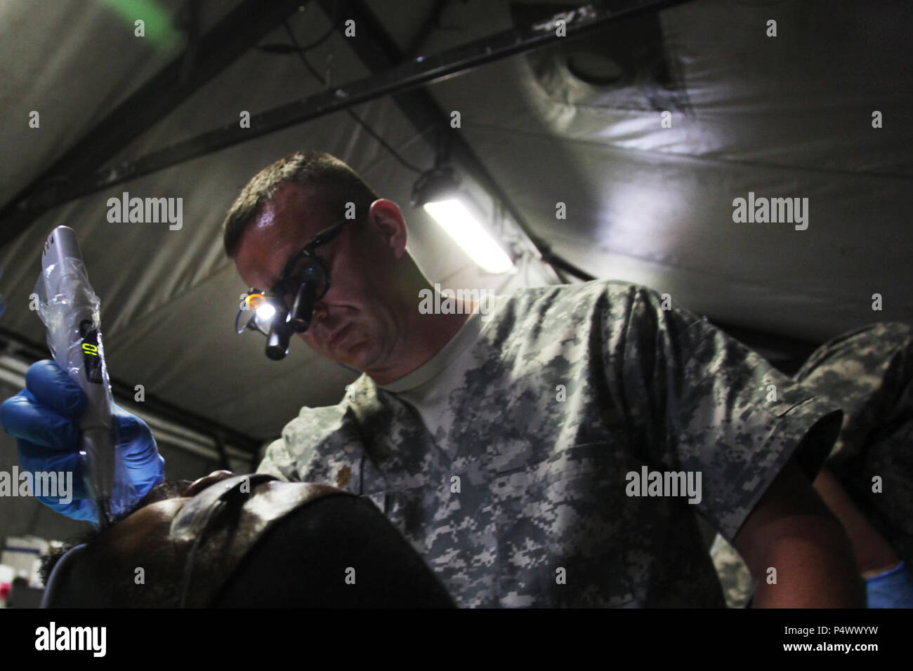U.S. Army Maj. Aaron Taff, attached to the Wyoming National Guard Medical Detachment, seals a filling during a medical readiness event held in San Ignacio, Belize, May 08, 2017. This is the second of three medical events that are scheduled to take place during Beyond the Horizon 2017. BTH 2017 is a U.S. Southern Command-sponsored, Army South-led exercise designed to provide humanitarian and engineering services to communities in need, demonstrating U.S. support for Belize. Stock Photo
