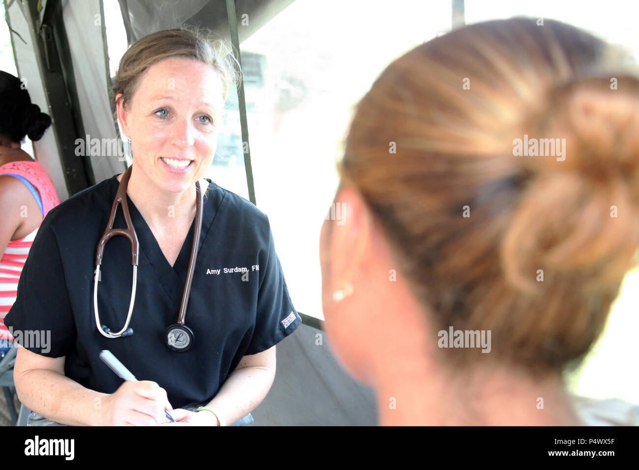 U.S. Army Lt. Col. Amy Surdan, with the Wyoming National Guard Medical Detachment, discusses the health of a Belizean local during a medical readiness event held in San Ignacio, Belize,  May 09, 2017. This is the second of three medical events that are scheduled to take place during Beyond the Horizon 2017. BTH 2017, a U.S. Southern Command-sponsored, Army South-led exercise designed to provide humanitarian and engineering services to communities in need, demonstrating U.S. support for Belize. Stock Photo