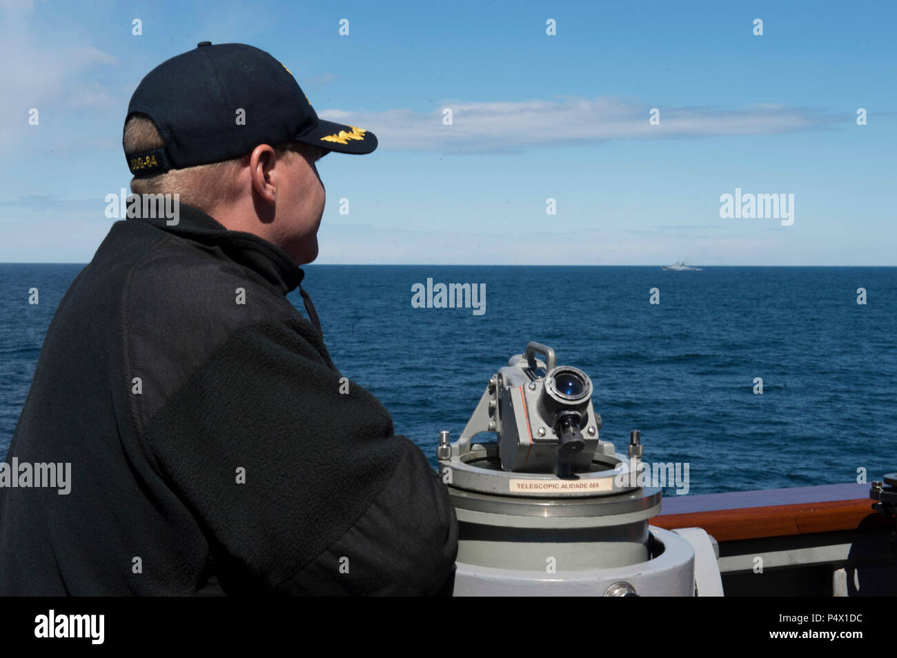 SEA (May 9, 2017) - Cmdr. Peter Halvorsen, commanding officer of the Arleigh Burke-class guided-missile destroyer USS Carney (DDG 64), watches the Russian Federation Steregushchiy-class frigate RFN Boiky (FFGHM 532) from the ship’s bridge wing while on patrol in the Baltic Sea, May 9, 2017. Carney, forward-deployed to Rota, Spain, is conducting its third patrol in the U.S. 6th Fleet area of operations in support of U.S. national security interests in Europe. Stock Photo