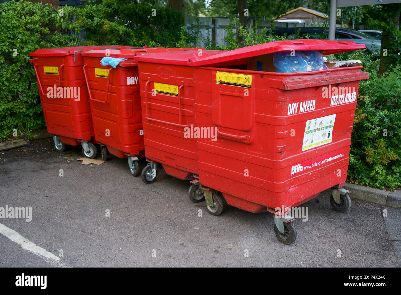 Four red trade waste Biffa bins Stock Photo