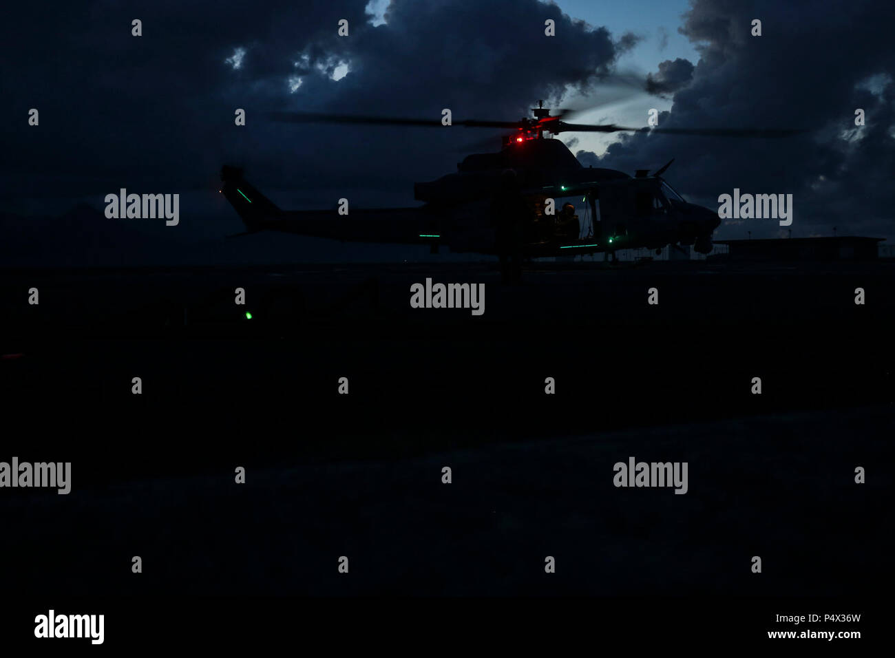 A U.S. Marine Corps UH-1Y Huey assigned to Marine Light Attack Helicopter Squadron 367 hovers over the ground at Landing Zone Westfield during a joint operation training exercise aboard Marine Corps Air Station Kaneohe Bay on May 10, 2017. The mission of HMLA-367 is to support the Marine Air-Ground Task Force commander by providing offensive air support, armed escort and airborne supporting arms coordination, day or night, under all weather conditions during expeditionary, joint, or combined operations. Stock Photo