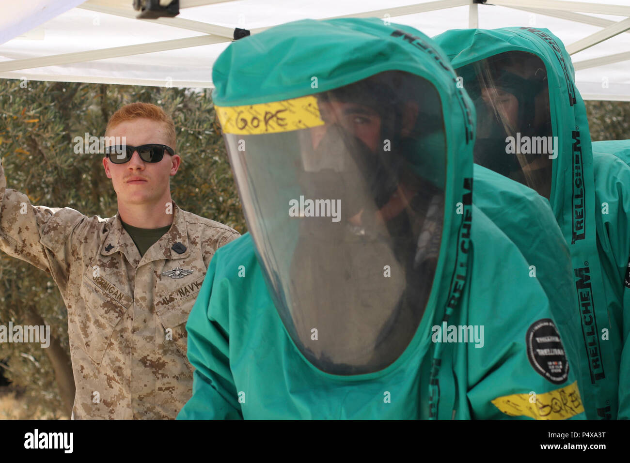 Petty Officer 3rd Class Corey Jernigan, a U.S. Navy hospital corpsman, looks on as U.S. Marines prepare take samples during a chemical, biological, radiological, nuclear training exercise, May 10, 2017, during Exercise Eager Lion at the Joint Training Center in Jordan. Jernigan, a reservist from Macon, Ga., is augmenting the U.S. Marine CBRN Platoon from Kansas City, Kan., participating in EL17. Stock Photo