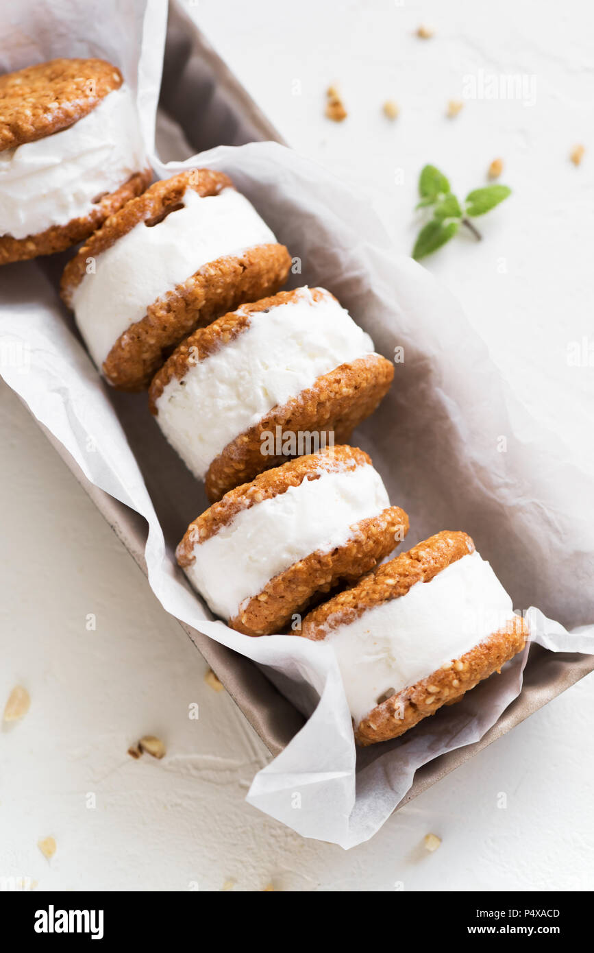 Ice cream sandwiches with nuts and wholegrain cookies. Homemade vanilla