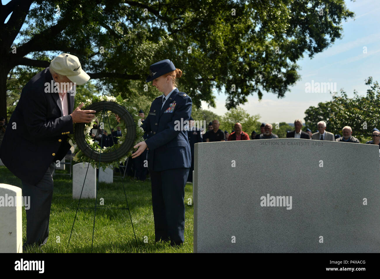 Retired Master Sgt. Joe Martin, 6994th Security Squadron Morse Code operator and Lt. Col. Laura Bunyan, 94th Intelligence Squadron commander, adjust the wreath placed in honor of the EC-43Q crew lost in 1973 on May 10, 2017. Stock Photo