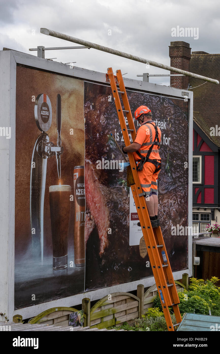 Advertising billboard maintenance or replacement worker Stock Photo Alamy