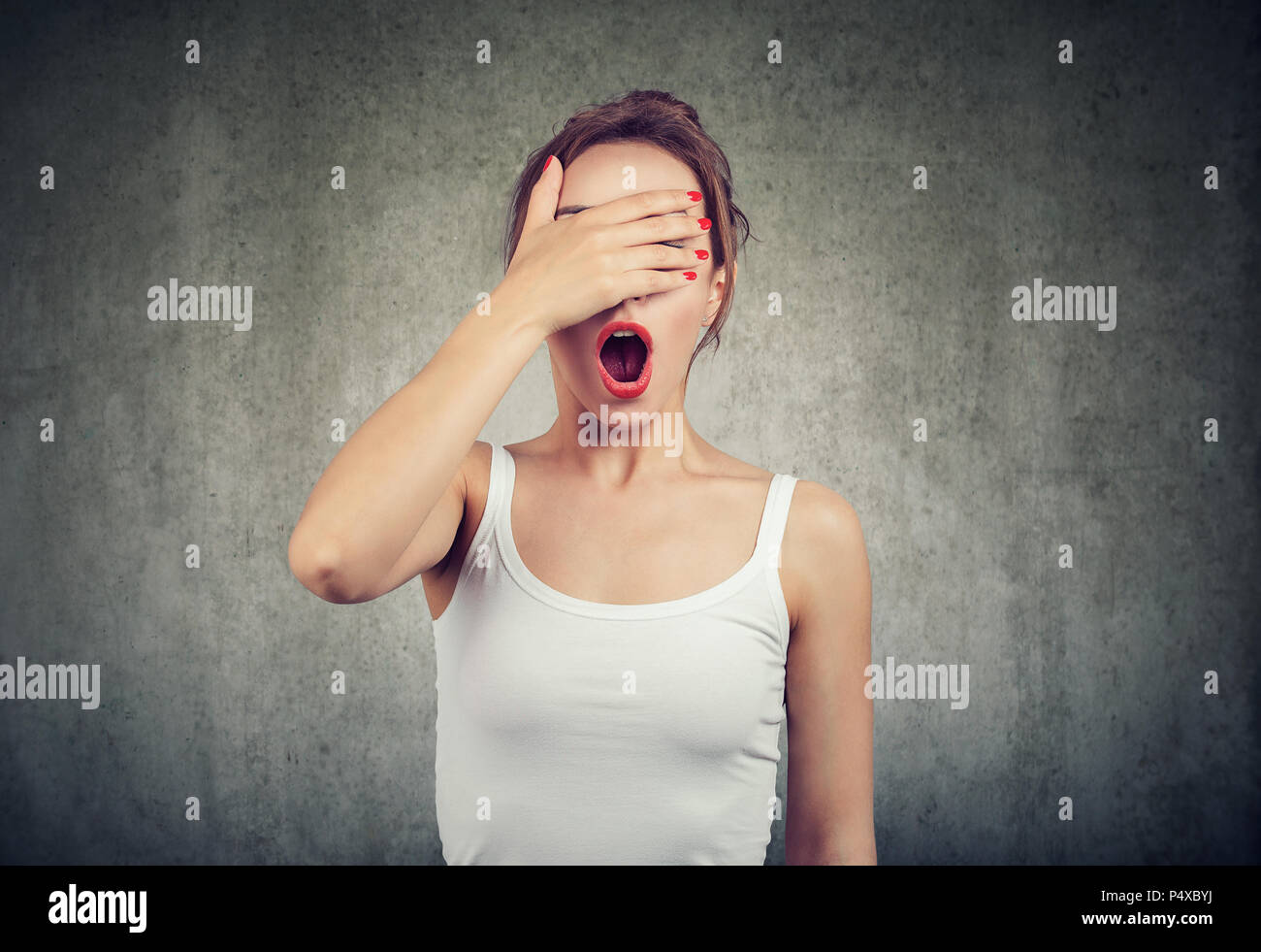 Young woman making a mistake feeling awkward in misunderstanding Stock Photo