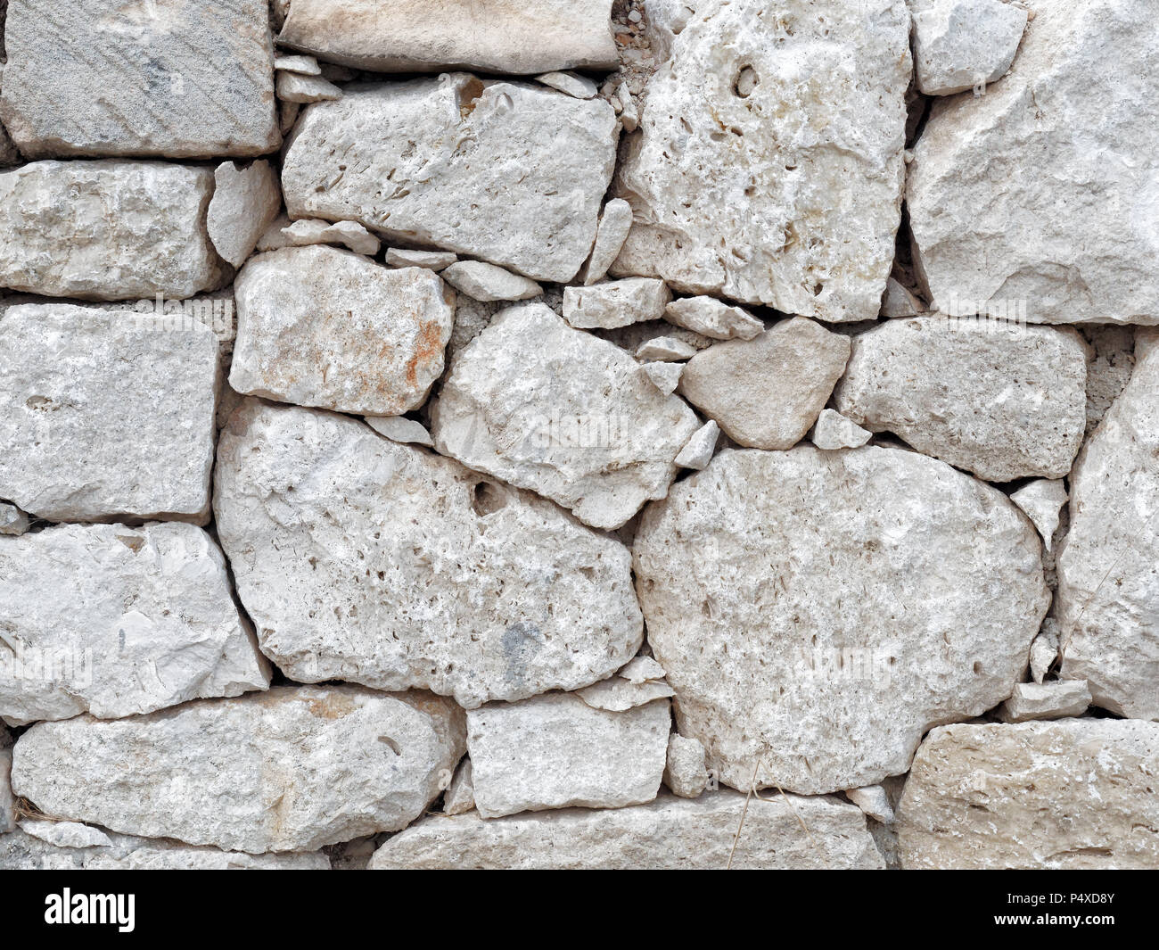 Dry wall of shaped stones front view Stock Photo - Alamy