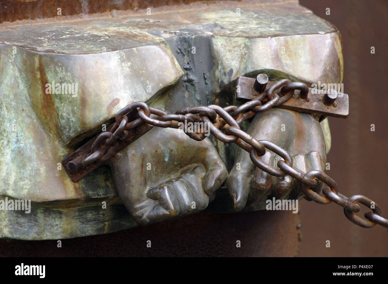 Italy. Rome. Monument dedicated to the victims of fascism and racism by sculptor Mimmo Paladino, born 1948. Detail of chained hands. Stock Photo