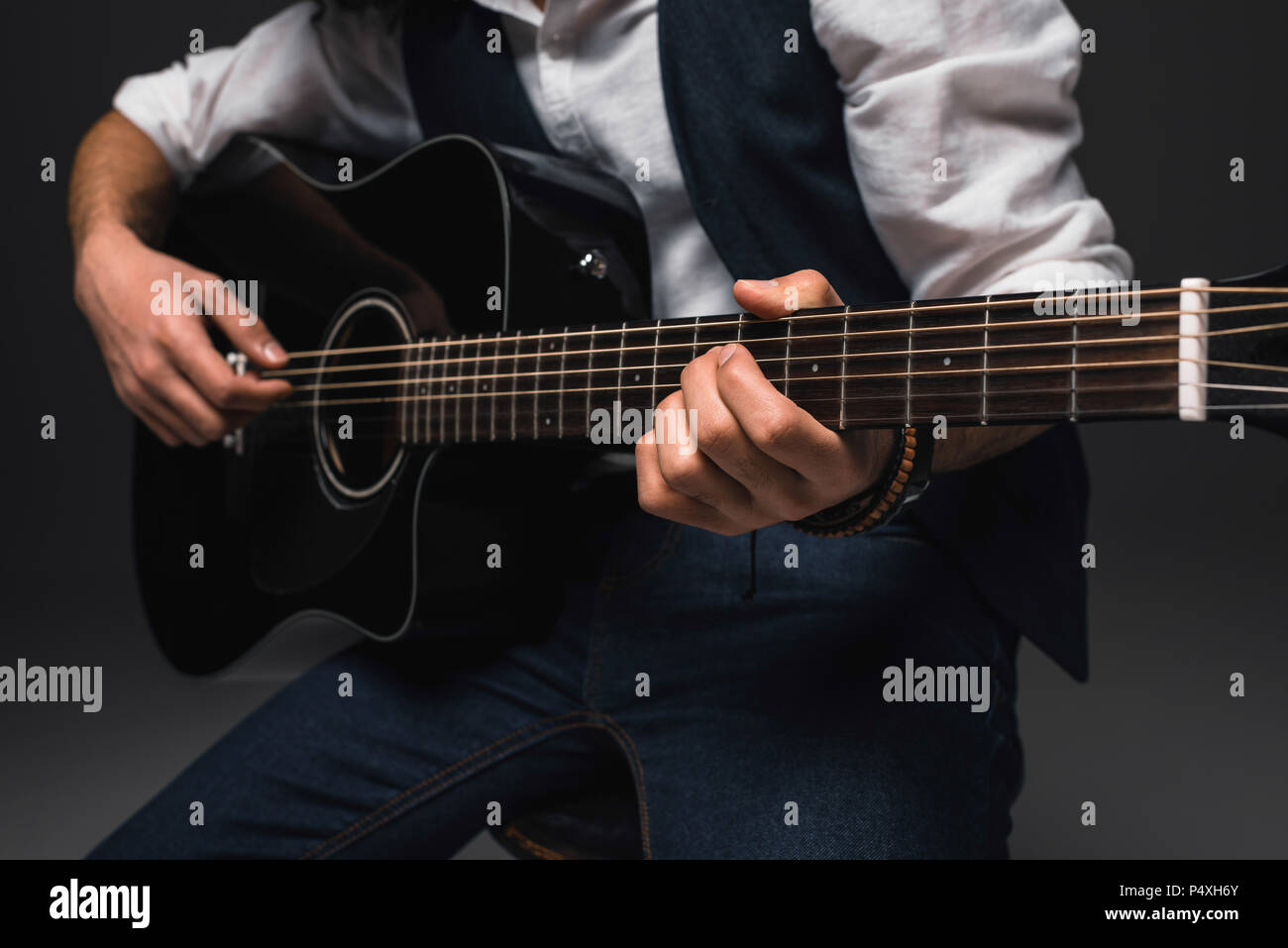 cropped shot of man playing acoustic guitar Stock Photo