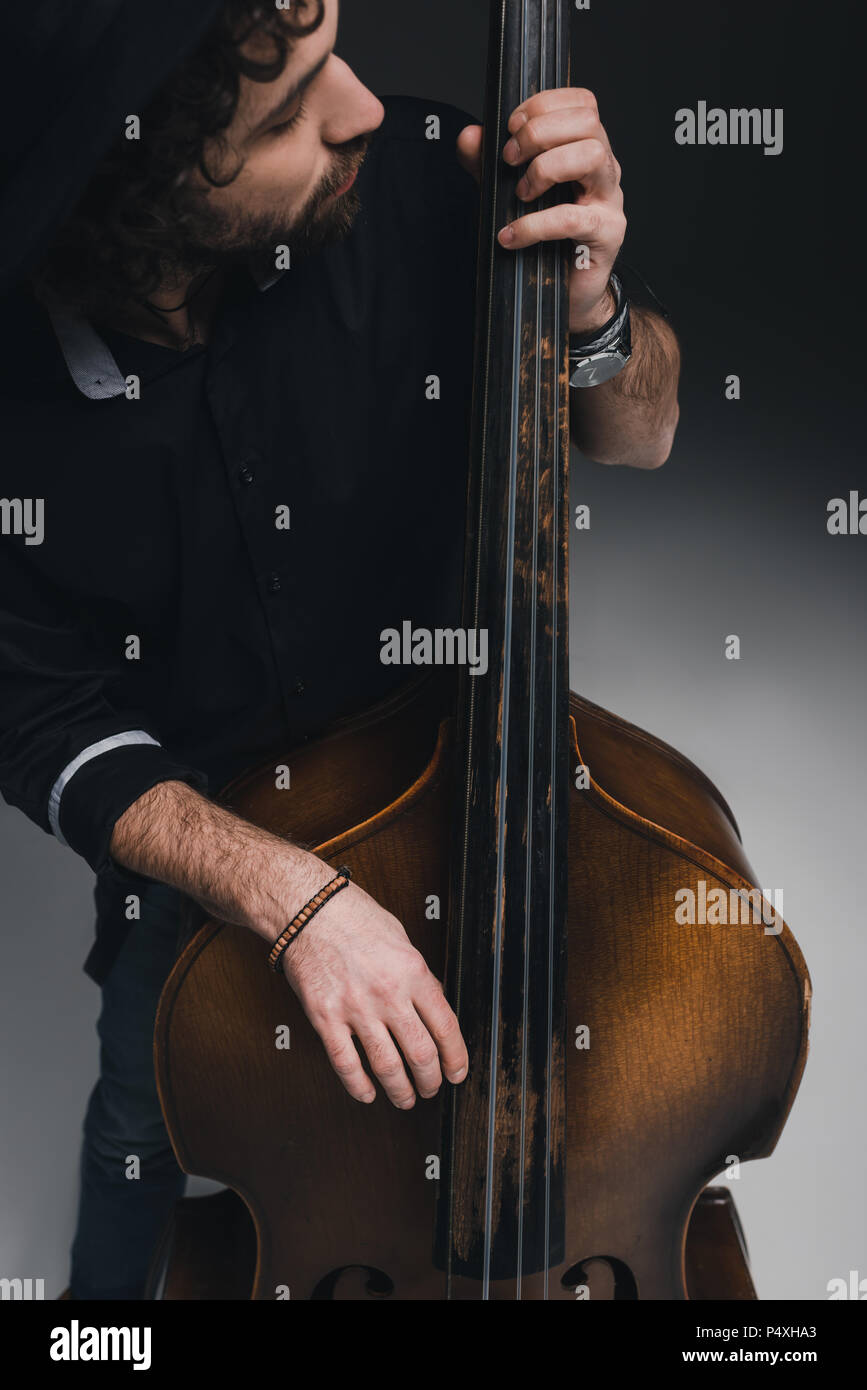 young handsome musician playing standup bass Stock Photo