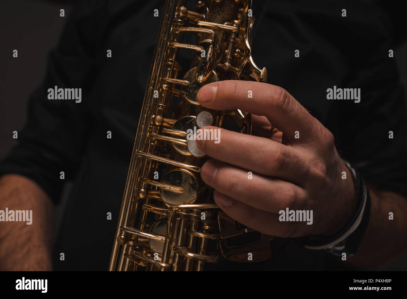 cropped shot of jazzman playing saxophone Stock Photo