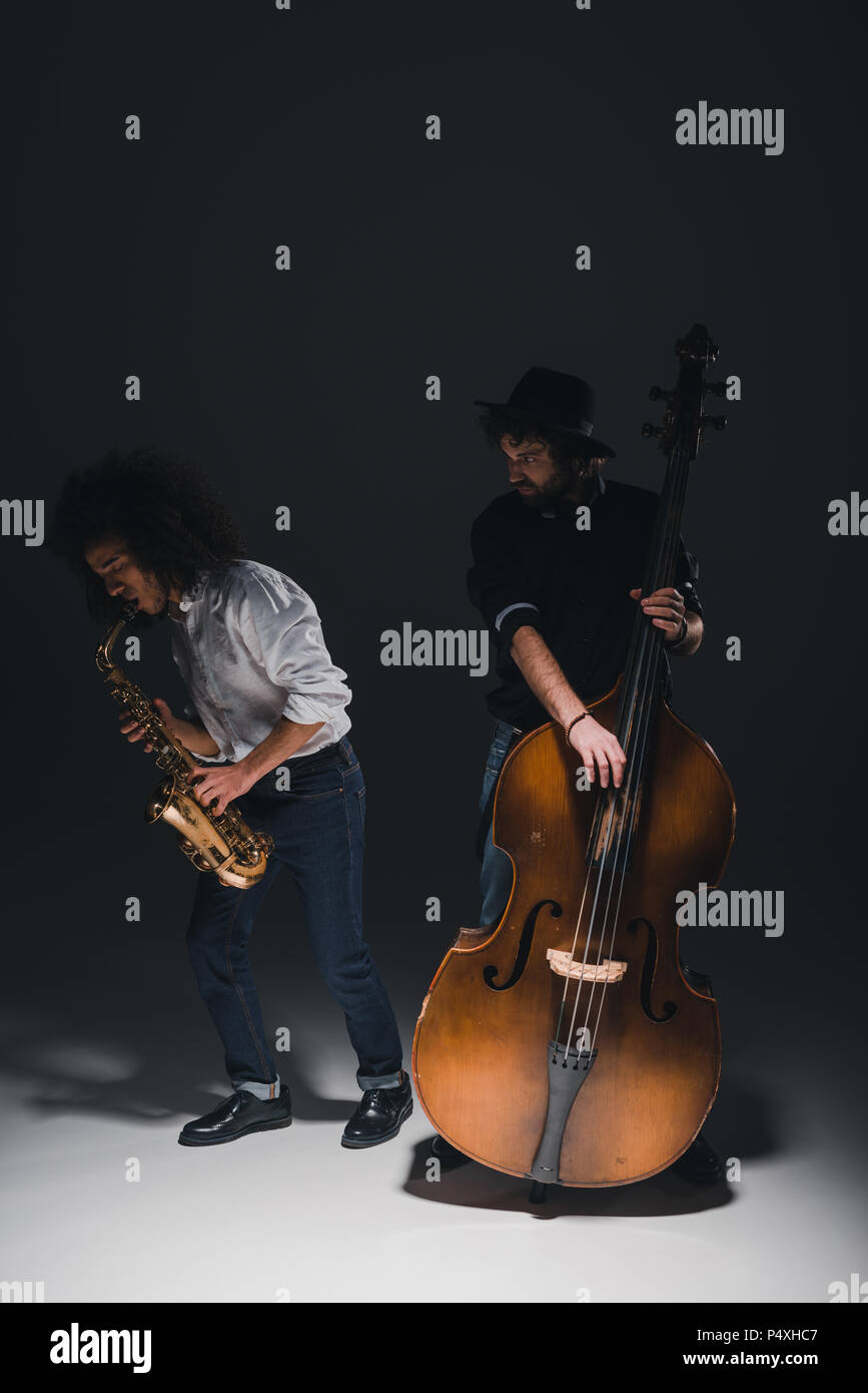 duet of jazzmen playing trumpet and saxophone on black Stock Photo Alamy