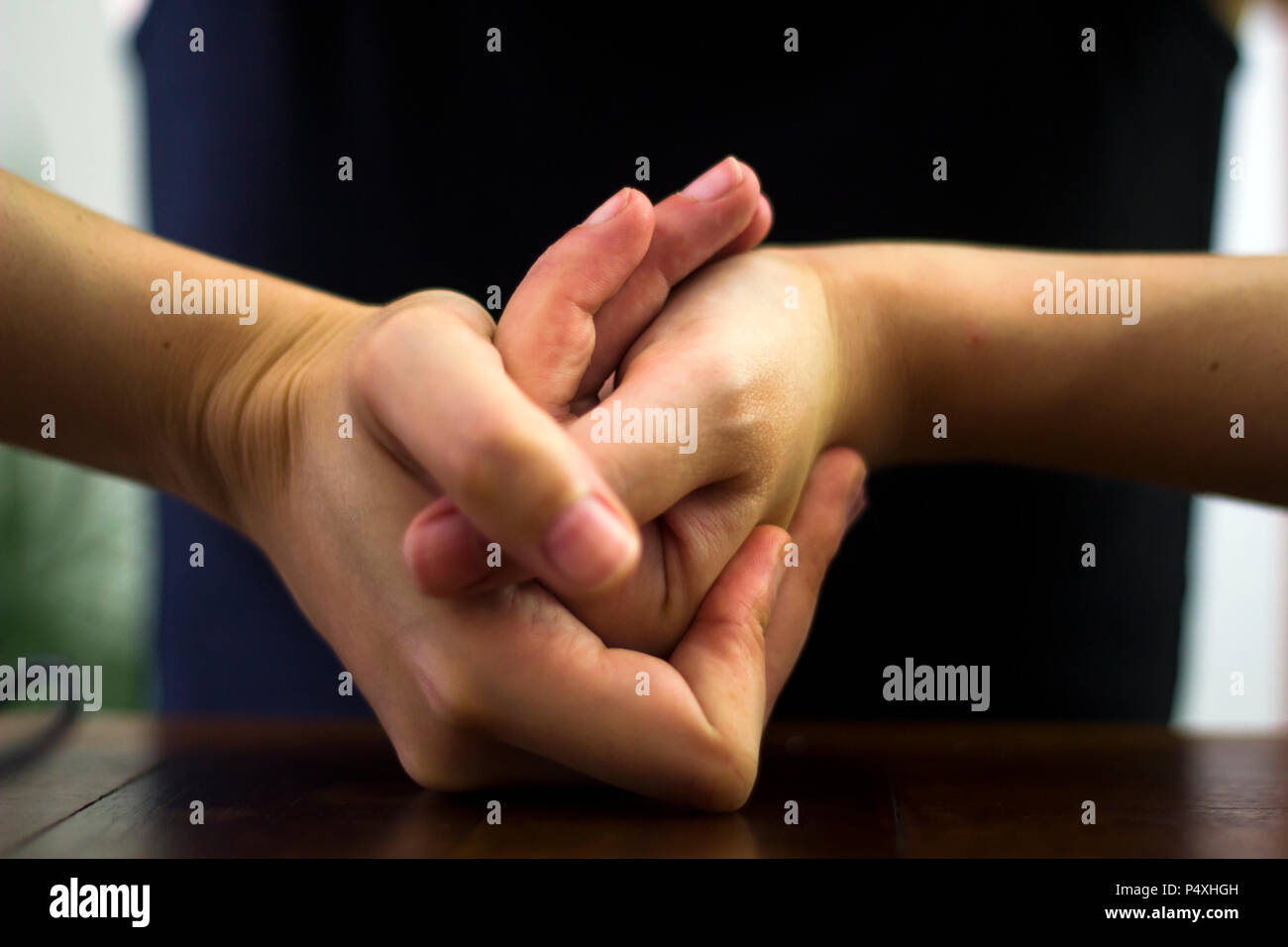 Woman cracking their knuckles Stock Photo