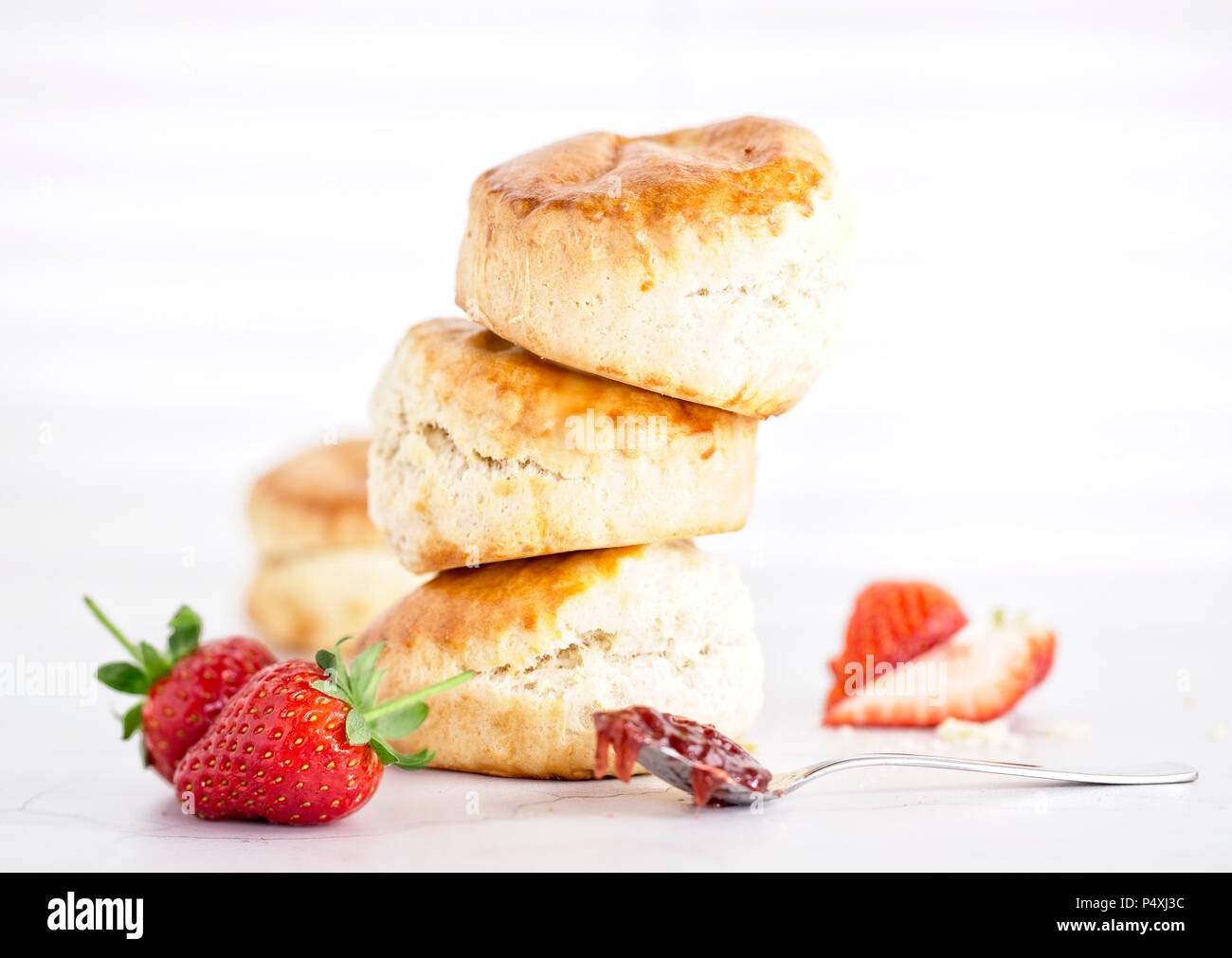 Cream Tea - scones with jam, cream and strawberry's on a white background Stock Photo