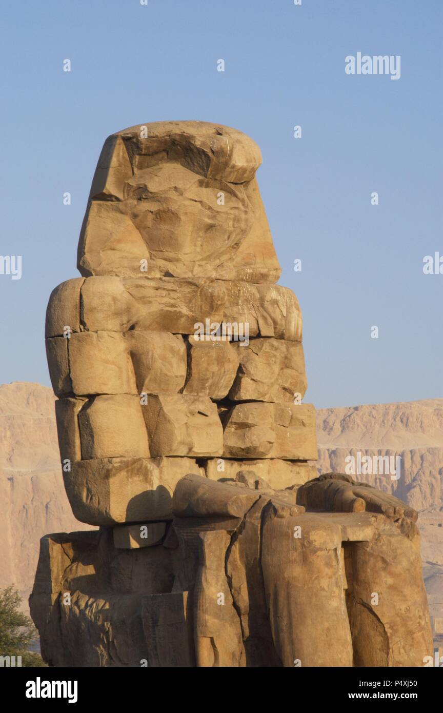 Colossi of Memnon. Stone statues depicting pharaoh Amenhotep III (14th century B.C.) in a seated position. Eastern colossus. Eighteenth Dynasty. New Kingdom. Luxor. Egypt. Stock Photo