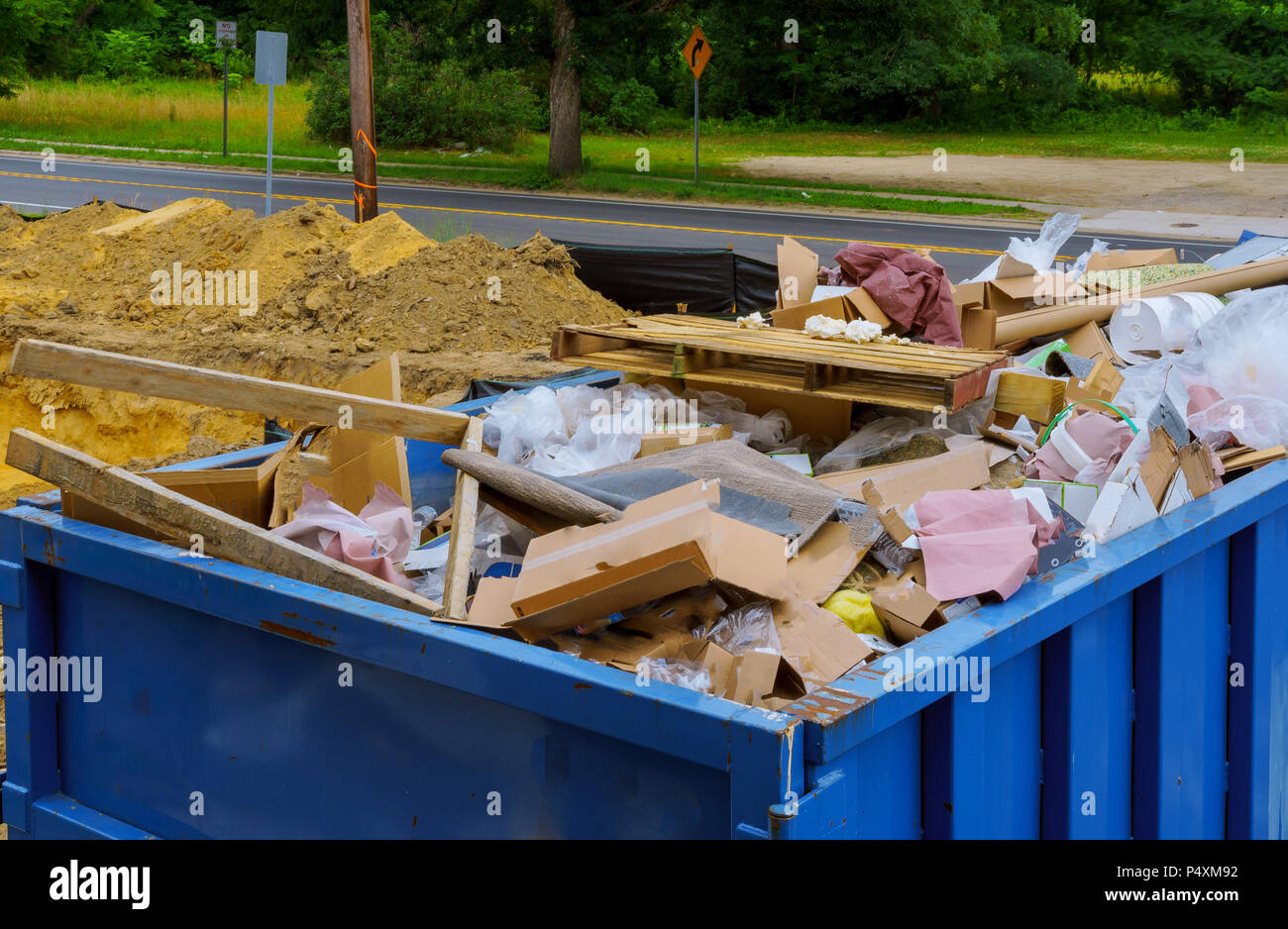 Industrial garbage bin blue construction debris container filled with