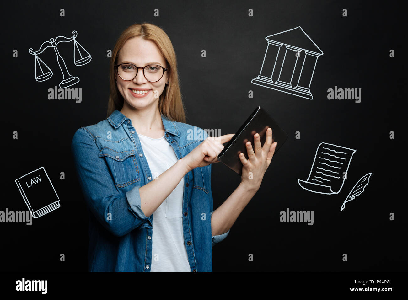 Cheerful lawyer standing with a tablet and looking confident Stock Photo
