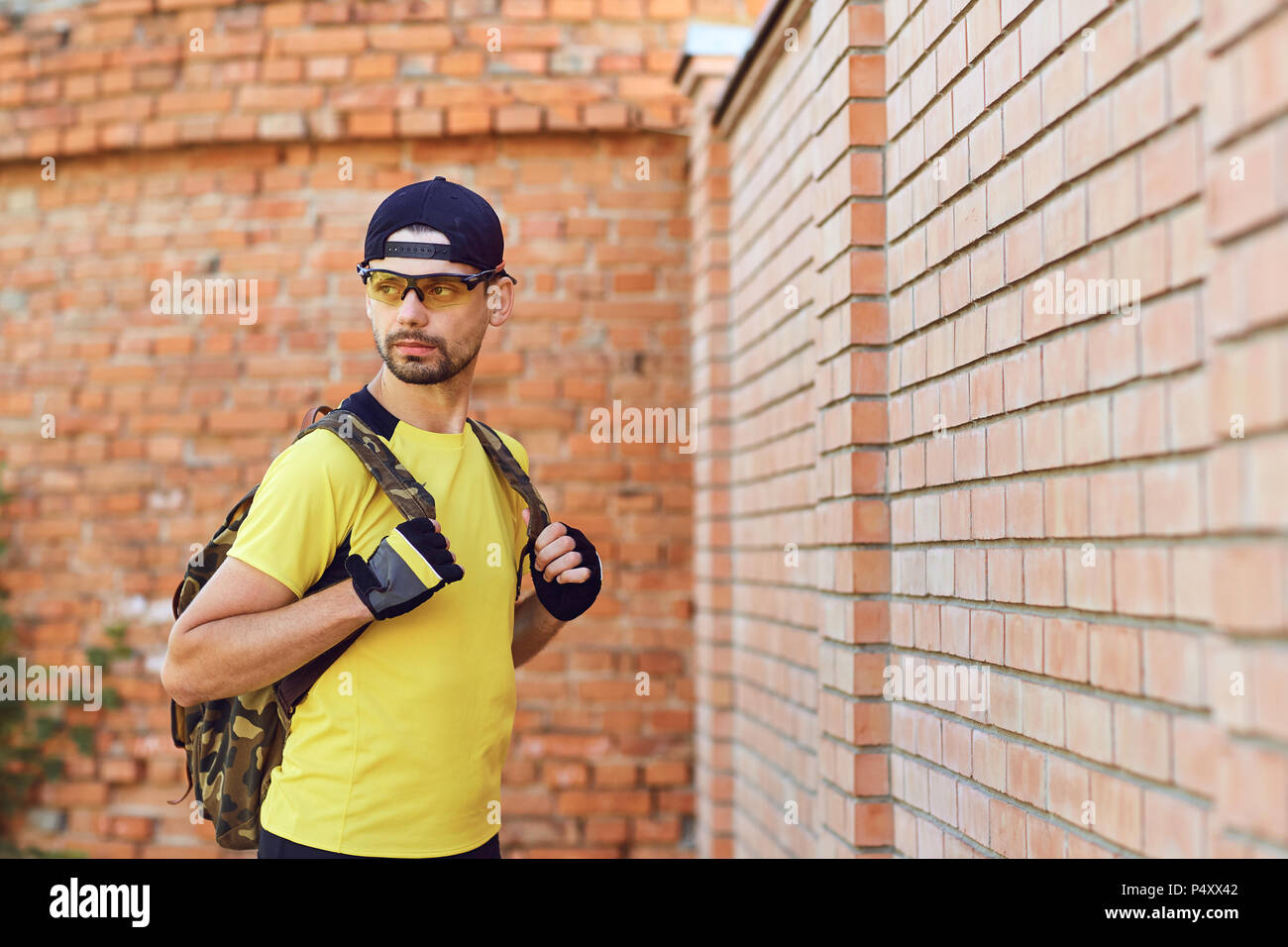 A man in sportswear with a backpack . Stock Photo