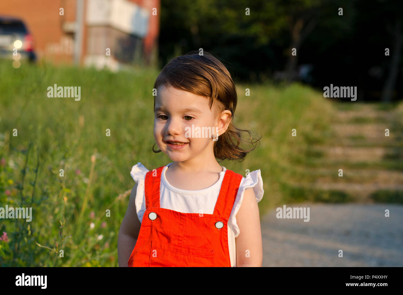 Small angel beauty with sparkling sunset in her eyes Stock Photo