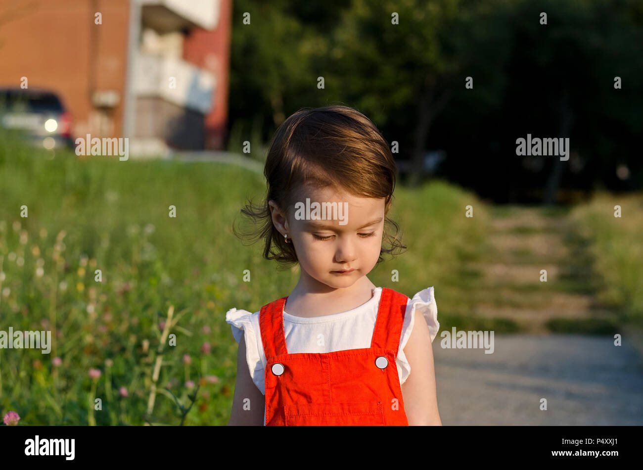 Small angel beauty with sparkling sunset in her eyes Stock Photo
