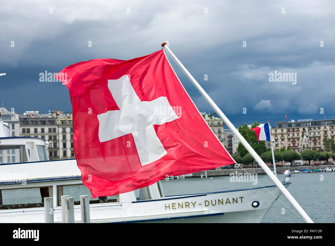 Geneva, Switzerland - june 07, 2018 : the national flag and the boat Henri Dunant in Geneva harbor Stock Photo