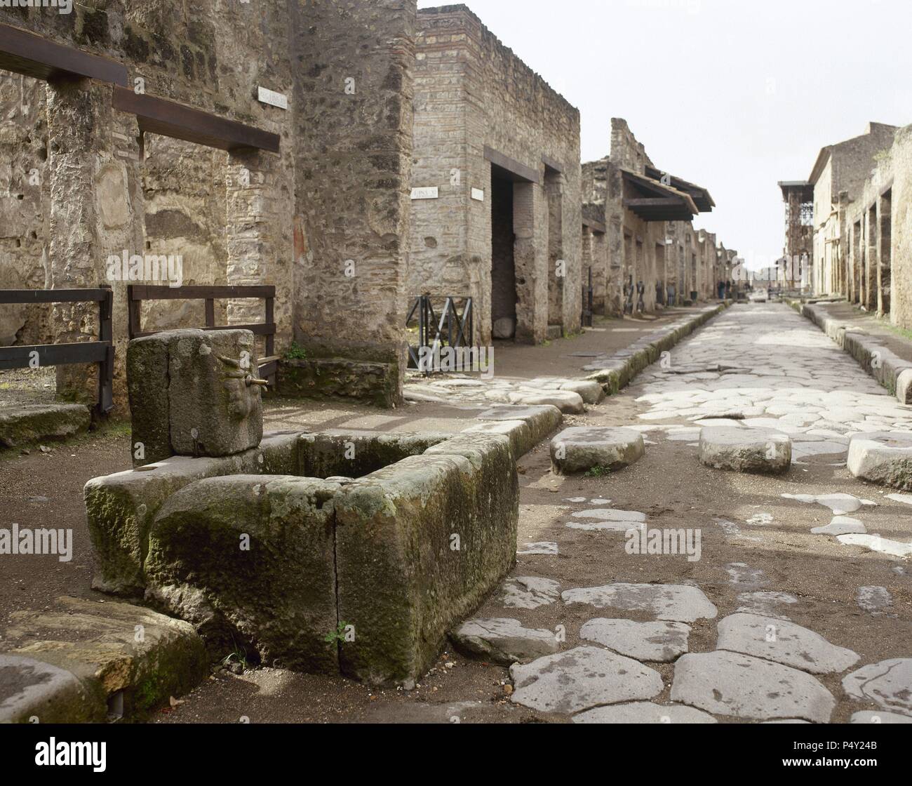 Pompeii. Ancient roman city. Fountain and stepping stone crossing. Abundance Street. Italy. Campania. Stock Photo
