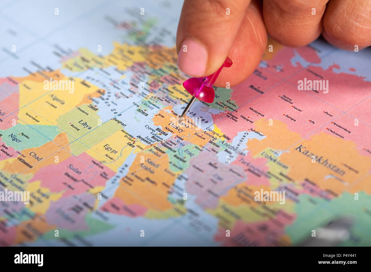 Hand marking Turkey on map with red pin Stock Photo