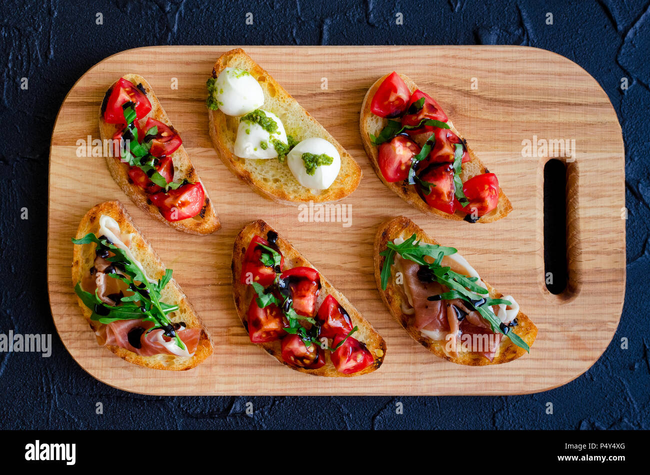 pics Bruschetta Recipe With Mozzarella And Pesto https www alamy com selection of tasty italian bruschetta on toasted baguette topped with tomatoes prosciutto di parma mozzarella balls with pesto sauce arugula and ba image209579624 html