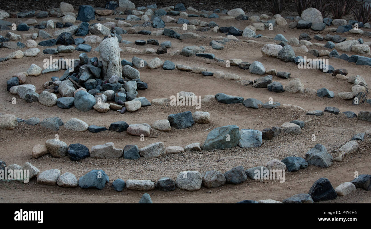 Traditional natural stone walking labyrinth mazze for contemplation and worship, created with rocks in shades of blue and turquoise. A calm, peaceful Stock Photo
