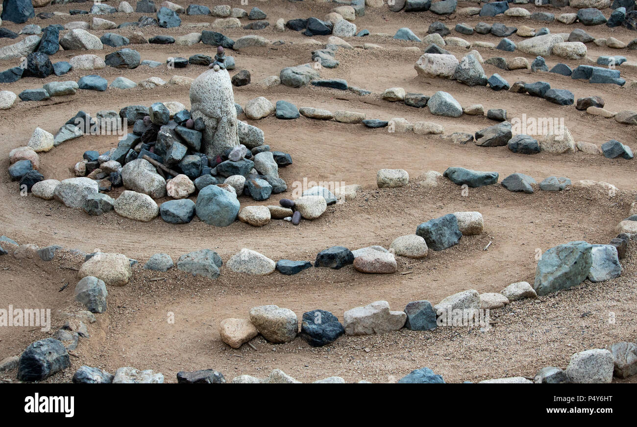 Traditional natural stone walking labyrinth mazze for contemplation and worship, created with rocks in shades of blue and turquoise. A calm, peaceful Stock Photo