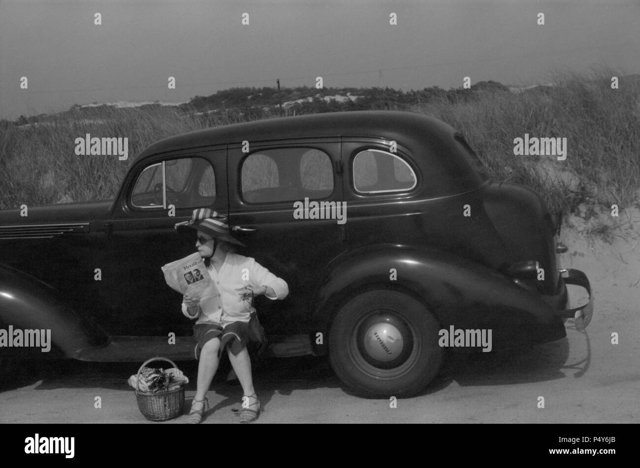 Woman Relaxing on Car at Beach, Provincetown, Massachusetts, USA, Edwin Rosskam, Farm Security Administration, August 1940 Stock Photo