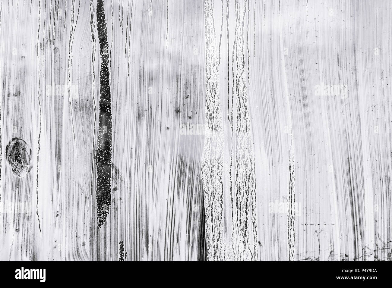 abstract hand painted glass surface background. whitewash paint blots on greenhouse windows Stock Photo