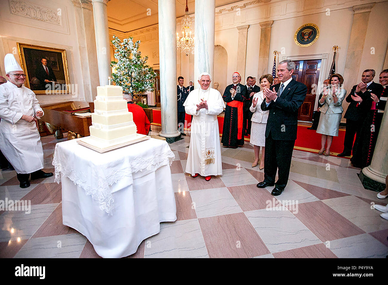 President George W. Bush and Mrs. Laura Bush lead the celebration of the 81st birthday of Pope Benedict XVI as he's presented a cake by White House Pastry Chef Bill Yosses Wednesday, April 16, 2008, at the White House. Stock Photo