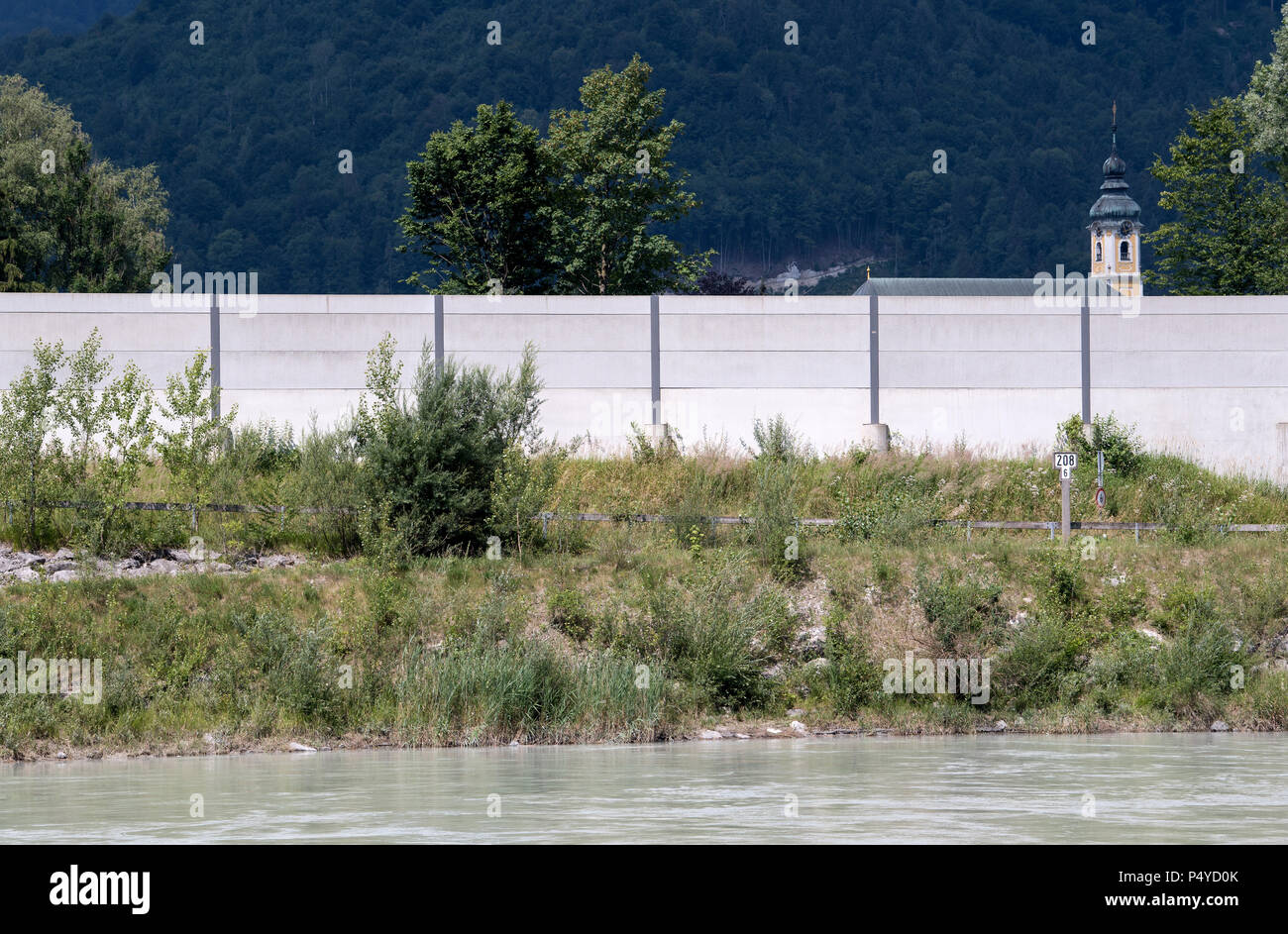 Windshausen, Germany. 21st June, 2018. A noise barrier of the freeway A 93 at the border crossing between Germany and Austria. The Inn river can be seen in the foreground, the church of Reisach can be seen in the background. Credit: Sven Hoppe/dpa/Alamy Live News Stock Photo