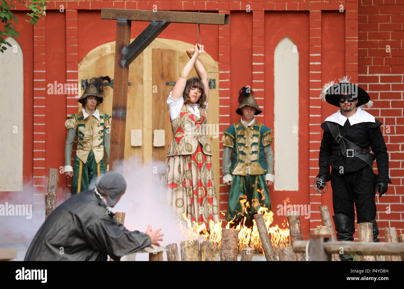 19 June 2018 Waren, Germany: Witch hunter Domberg (L, Hardy Halama) forces apothecaries' daughter Laura (Anna Marie Lehmann) onto the pyre during the theatre piece 'Im Bann des Hexenjaegers' (lit. 'Under the spell of the witch hunter'). The premiere of the piece, which is part of the 'Mueritz Saga' will be held on the 30th of June at the open air theatre in Waren. Photo: Bernd Wüstneck/dpa Stock Photo
