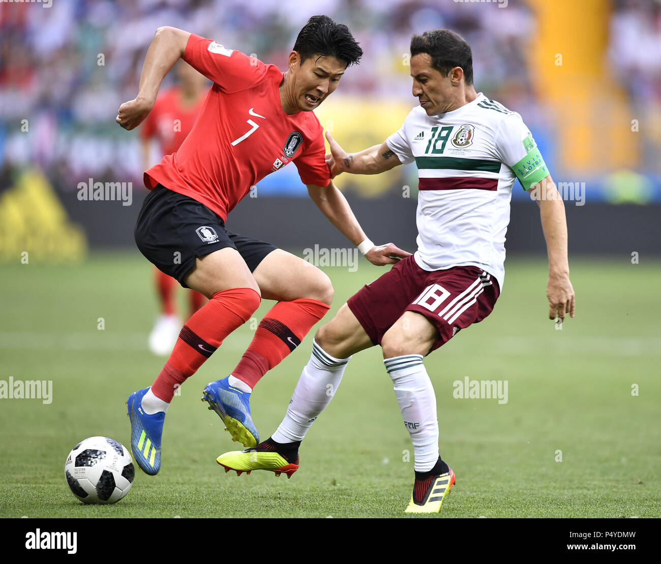 Rostov On Don. 23rd June, 2018. Son Heungmin (L) of South Korea vies with Andres Guardado of Mexico during the 2018 FIFA World Cup Group F match between South Korea and Mexico in Rostov-on-Don, Russia, June 23, 2018. Credit: Chen Yichen/Xinhua/Alamy Live News Stock Photo