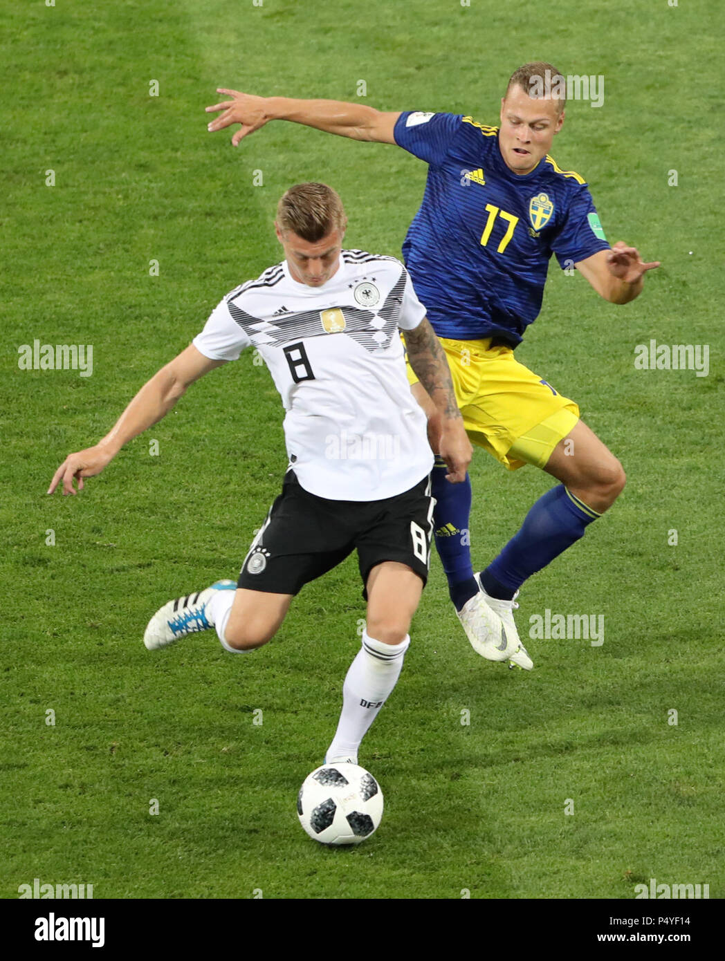 Sochi, Russia. 23rd June, 2018. Toni Kroos (L) of Germany vies with Viktor Claesson of Sweden during the 2018 FIFA World Cup Group F match between Germany and Sweden in Sochi, Russia, June 23, 2018. Credit: Ye Pingfan/Xinhua/Alamy Live News Stock Photo