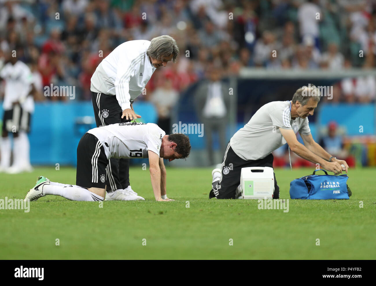 Sochi, Russia. 23rd June, 2018. Sebastian Rudy (L bottom) of Germany receives medical treatment after his injury during the 2018 FIFA World Cup Group F match between Germany and Sweden in Sochi, Russia, June 23, 2018. Credit: Lu Jinbo/Xinhua/Alamy Live News Stock Photo