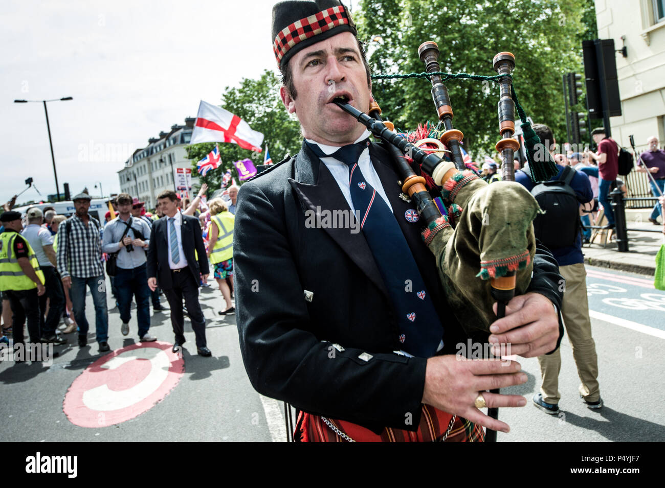 London, UK. 23rd June, 2018. Bagpiper performing during the march to the Parliament. The UK Unity and Freedom March was a celebration of the vote to leave the European Union. Credit: SOPA Images Limited/Alamy Live News Stock Photo