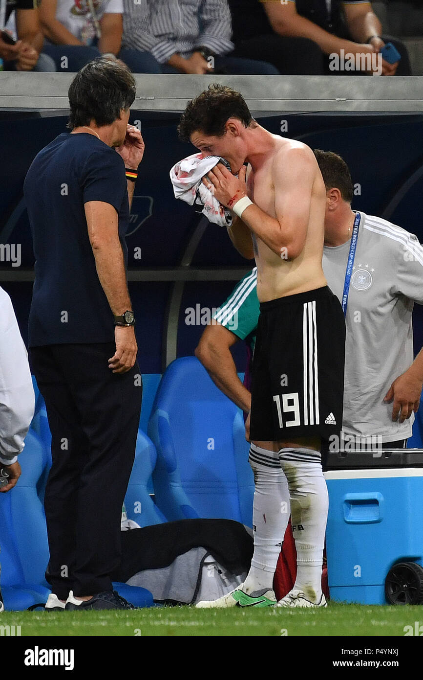 Sochi, Russia. 23rd June, 2018. Sebastian RUDY (GER) wipes his bleeding nose with his jersey. Injury, hurt. Li: Federal coach Joachim Jogi LOEW, LOW (GER). Germany (GER) -Sweden (SWE) 2-1, Preliminary Round, Group F, Match 27, on 23.06.2018 in SOCHI, Fisht Olymipic Stadium. Football World Cup 2018 in Russia from 14.06. - 15.07.2018. | usage worldwide Credit: dpa/Alamy Live News Stock Photo