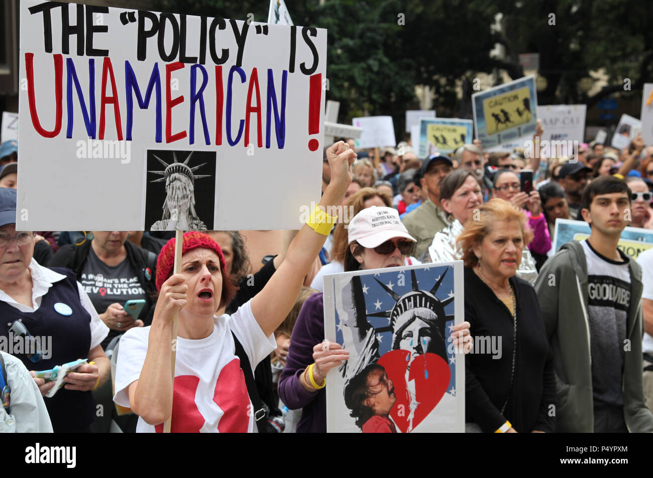 San Diego, USA. 23rd June, 2018. People take part in the 'Families Belong Together' protest in San Diego, the United States, on June 23, 2018. Thousands of people marched in protest in the U.S.-Mexico border city of San Diego on Saturday, raising slogans against the Trump administration's policy of separating children from immigrant parents. Credit: Gao Shan/Xinhua/Alamy Live News Stock Photo