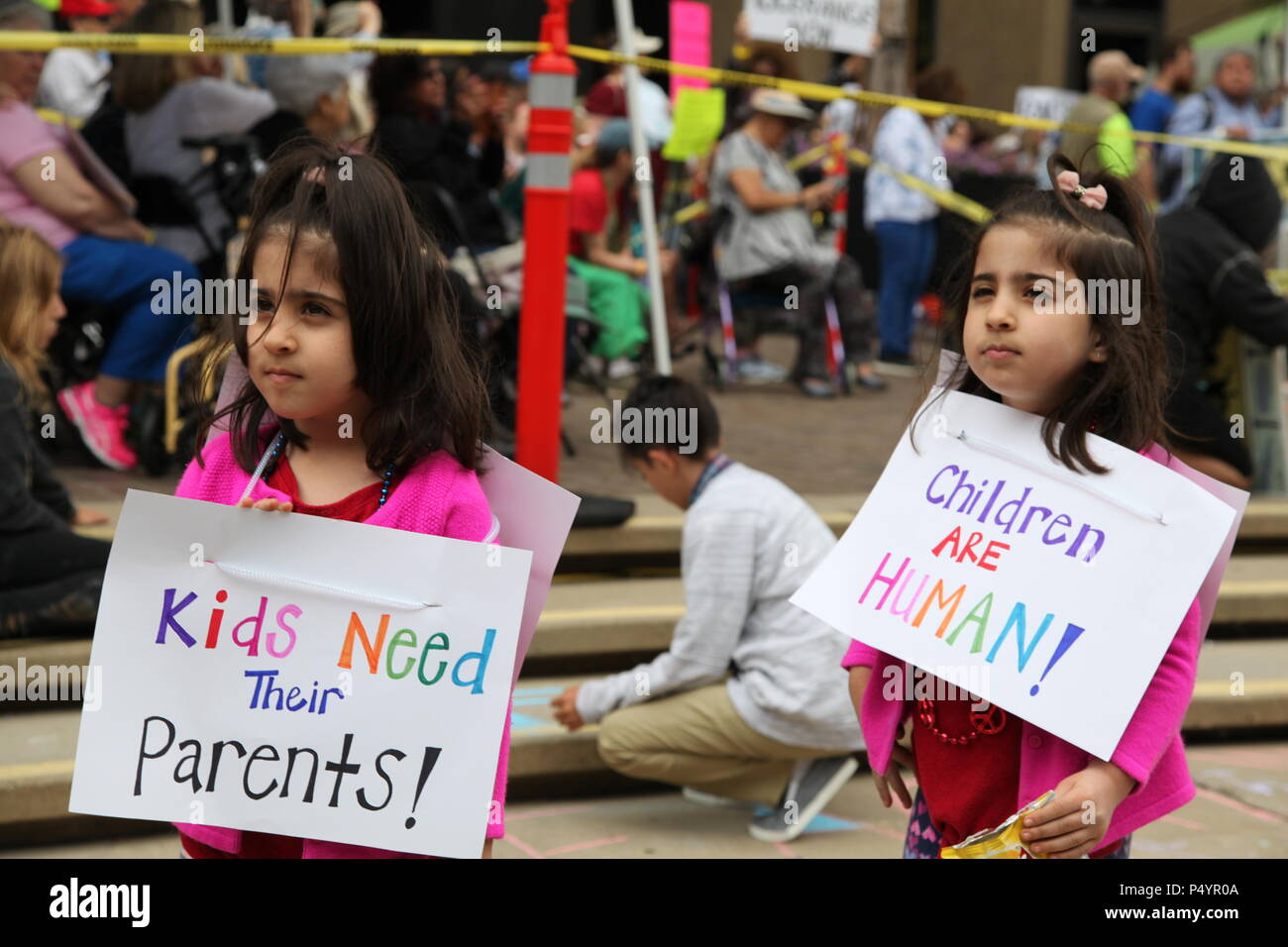 San Diego, USA. 23rd June, 2018. Two girls take part in the 'Families Belong Together' protest in San Diego, the United States, on June 23, 2018. Thousands of people marched in protest in the U.S.-Mexico border city of San Diego on Saturday, raising slogans against the Trump administration's policy of separating children from immigrant parents. Credit: Gao Shan/Xinhua/Alamy Live News Stock Photo