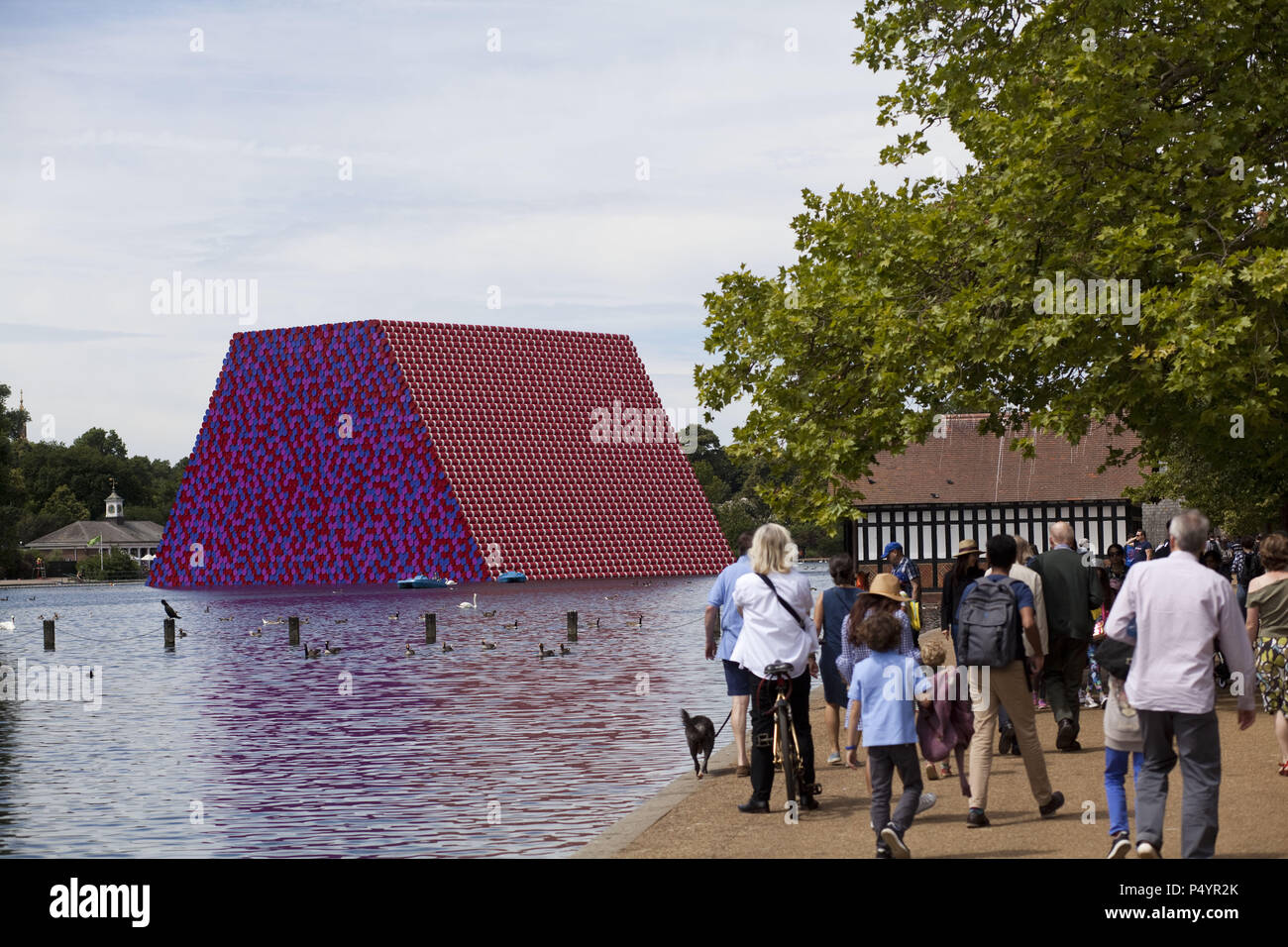 London, UK. 23 June 2018 The Mastaba, a temporary sculpture made of stacked barrels in Serpentine Lake in Hyde Park, is made by one of the world's most celebrated artists, famous for ambitious large scale works. Christo and his late wife Jean-Claude took an inspiration from ancient mastabas (benches) structures that originated in first urban civilisatons of Mesopotamia. Twenty metres in height, the structure consists of 7506 horizontally-stacked coloured barrels. The sculpture coincides with Serpentine Galleries exhibition of Christo and Jeanne-Claude's use of barrels in their work over th Cre Stock Photo