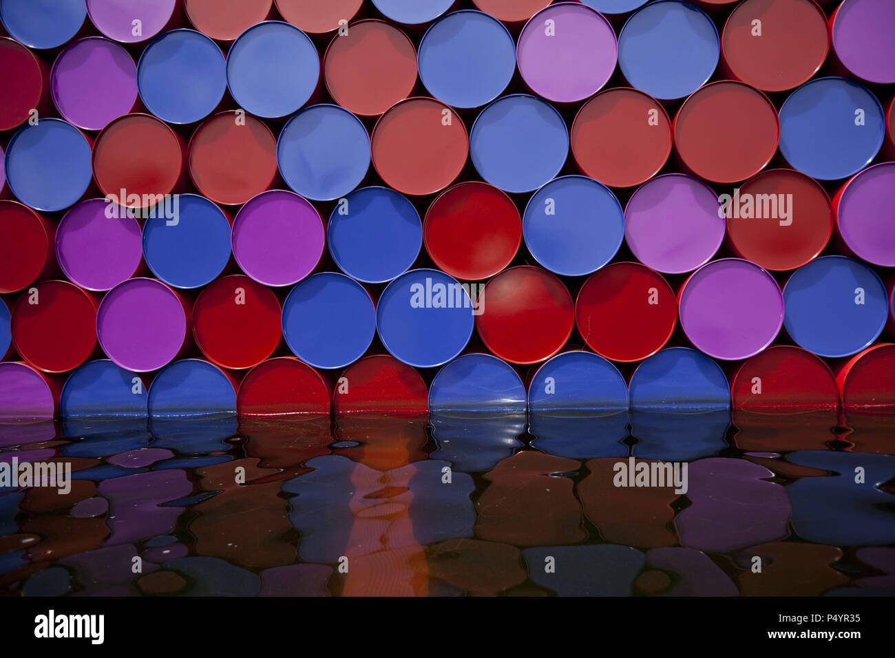 London, UK. 23 June 2018 The Mastaba, a temporary sculpture made of stacked barrels in Serpentine Lake in Hyde Park, is made by one of the world's most celebrated artists, famous for ambitious large scale works. Christo and his late wife Jean-Claude took an inspiration from ancient mastabas (benches) structures that originated in first urban civilisatons of Mesopotamia. Twenty metres in height, the structure consists of 7506 horizontally-stacked coloured barrels. The sculpture coincides with Serpentine Galleries exhibition of Christo and Jeanne-Claude's use of barrels in their work over th Cre Stock Photo